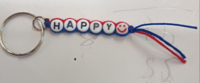Handmade beaded keyring spelling HAPPY with a smiley face