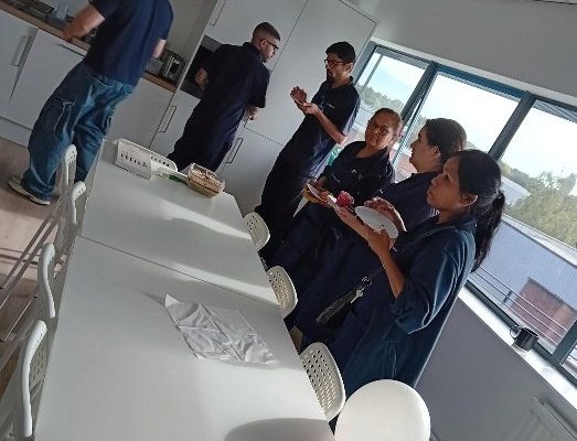Colleagues helping themselves at the coffee morning in the Birmingham staff room