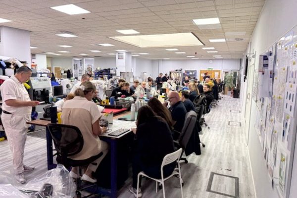 Crispin colleagues seated at workbenches across the workshop floor during Bingo