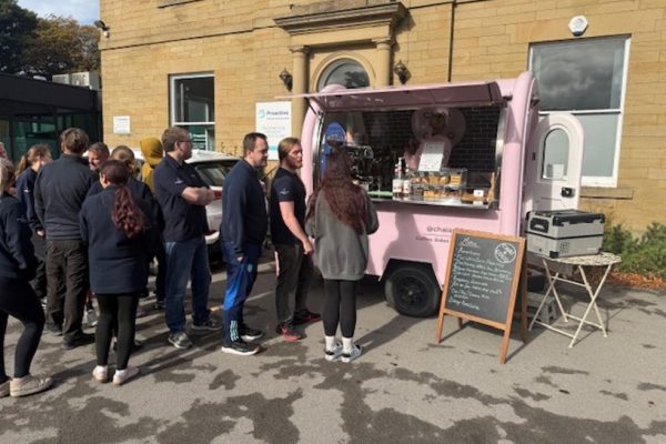 Colleagues queuing at a pink coffee van outside the Crispin building