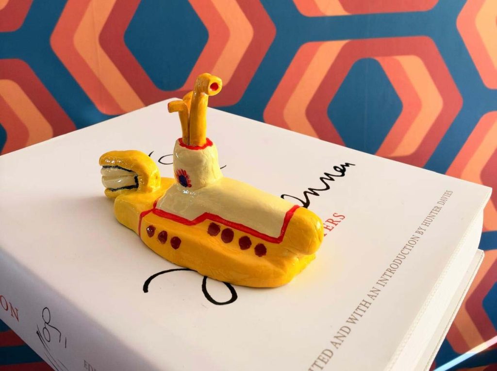 Aaron's clay submarine, painted yellow with red trim and portholes